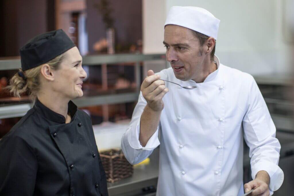 A chef tasting Acadian redfish